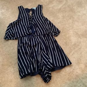 Navy romper with white stripes.